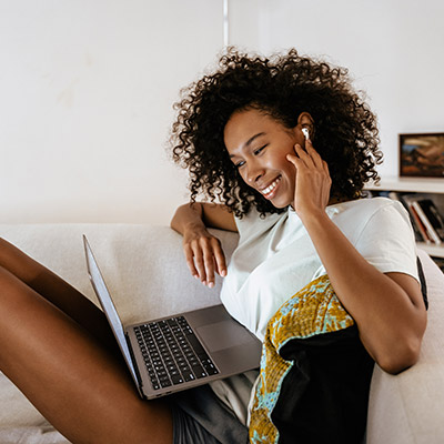 Young happy woman on laptop