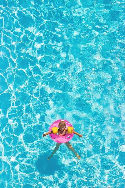 Vertical stock photo of girl in a pool